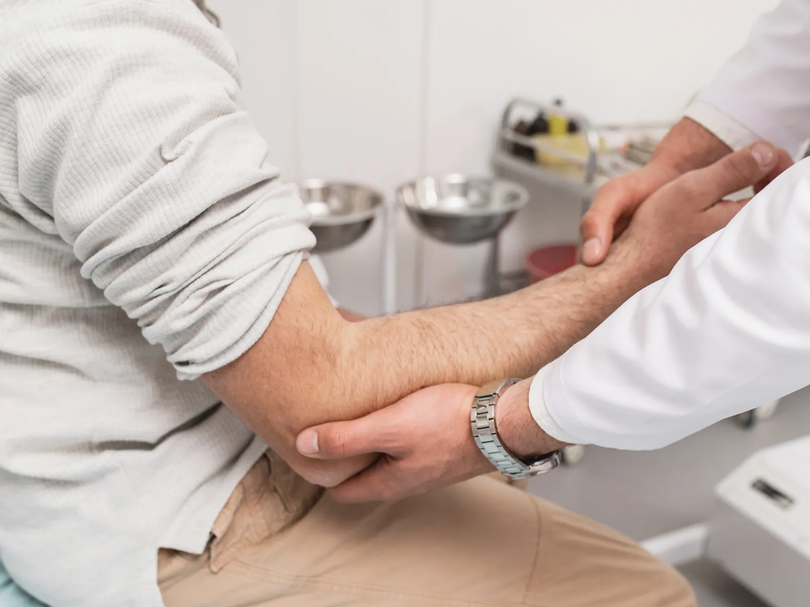 Clinician assessing a patient's elbow range of motion