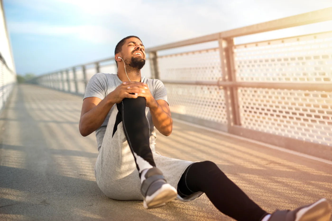 man suffering from activity related knee pain