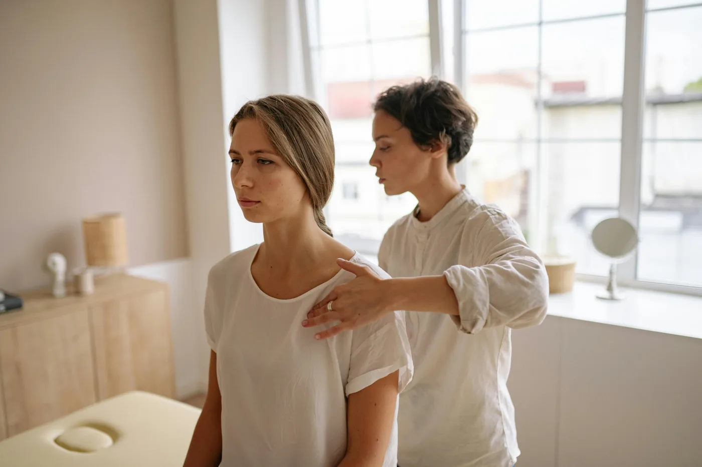 clinician assessing a patient's shoulder mobility during an exam in Millburn NJ